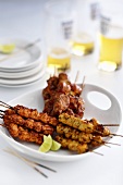 Different kinds of meat on skewers, glasses of beer
