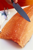 Filleted salmon with filleting knife