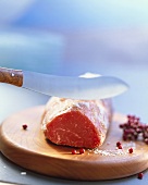 Frozen veal fillet with knife