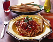 Spaghetti with meatballs, tomato sauce and sesame sticks