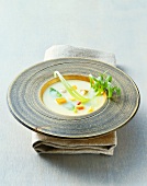 Coconut soup with vegetables in wooden plate