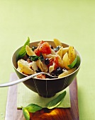 Penne with tomatoes, olives, basil and Parmesan