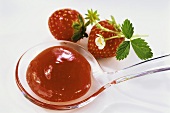 Strawberry jam on plastic spoon