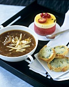 Onion soup with bread and cheese and passion fruit mousse