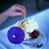 Blueberry ice cream with whipped cream and praline
