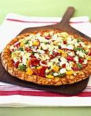 Pizza with vegetables and feta