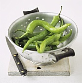 Green chili peppers in a colander