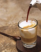 Pouring espresso on to latte macchiato