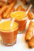 Freshly pressed carrot juice and carrots