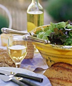 Green salad, white wine and bread