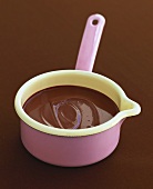 Melted chocolate in a pink enamel saucepan