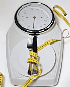 Bathroom scales with plate, cutlery and tape measure
