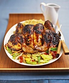 Roast chicken, opened out, on vegetables