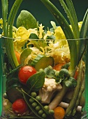 Salad and fresh vegetables in glass bowl