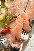 Salmon with herbs steamed in aluminium foil (detail)