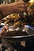 Taking coffee beans out of a storage container