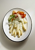 White asparagus with ham, herb sauce and Parmesan