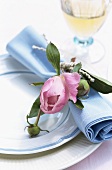 Place setting with fabric napkin and peony