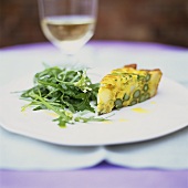 A piece of asparagus frittata with rocket salad