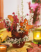 Arrangement of heather and autumn leaves