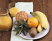 Plate of fruit and orange juice