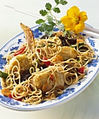 Guinea-fowl with egg noodles cooked in wok
