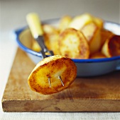 Roasted potatoes in a bowl and on fork