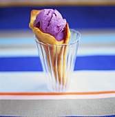 Blueberry ice cream with waffle cone in glass