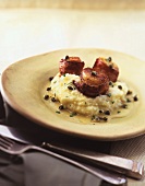 Scallop wrapped in bacon on mashed potato