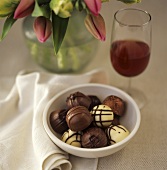 Chocolates, red wine and bouquet of tulips
