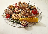 Various barbecue foods on grill rack