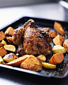 Roast chicken with vegetables on a baking tray