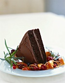 A piece of chocolate cake garnished with fruit