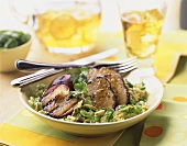 Grilled pork with prunes and salad