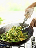 Mixed vegetables being cooked in a wok