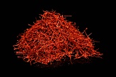 Heap of red saffron on black background