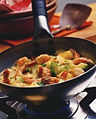 Shrimps with vegetables in a frying pan