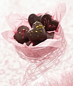 Heart-shaped chocolates with pink paper