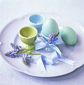 Coloured eggs, eggcups and grape hyacinths