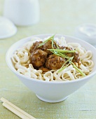 Noodles with meatballs and spring onions