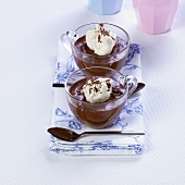 Chocolate puddings with blobs of cream
