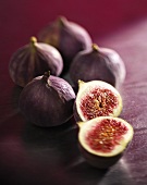 Several whole figs and one halved fig