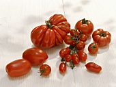 Various types of tomatoes on white background