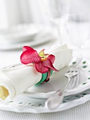 A place setting with napkin and napkin ring