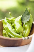 Green chili peppers in a wooden bowl