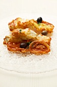 Fried cod fillet with tomato sauce and olives