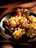 Pink grapes in a wooden bowl