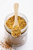 Pollen in a jar and on a wooden spoon