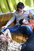 Three young men relaxing with beer