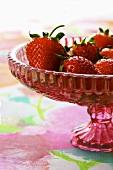 Fresh strawberries in a glass pedestal bowl